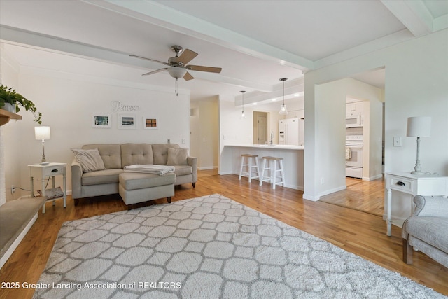 2130 Belding Ct, Okemos, MI 48864 - living area featuring beamed ceiling, wood finished floors, and ceiling fan