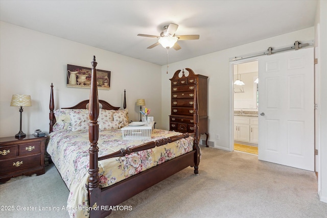 2130 Belding Ct, Okemos, MI 48864 - bedroom featuring light colored carpet, a barn door, ensuite bath, and ceiling fan