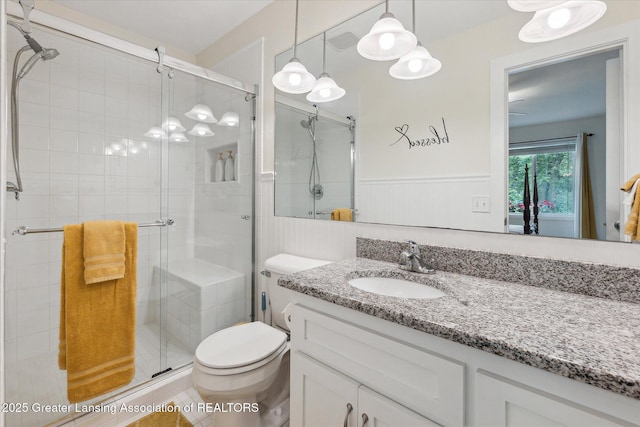 2130 Belding Ct, Okemos, MI 48864 - full bathroom featuring vanity, a stall shower, and a wainscoted wall