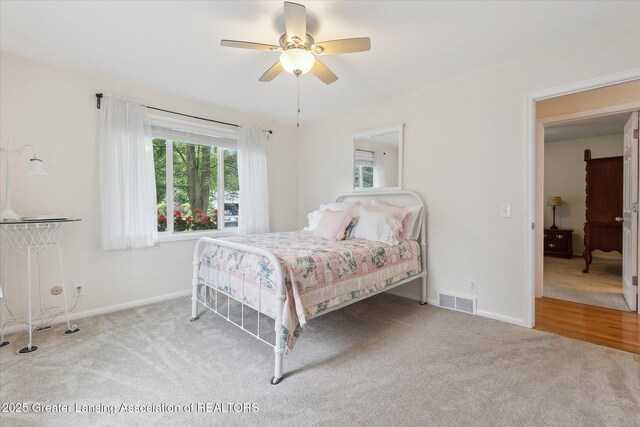 2130 Belding Ct, Okemos, MI 48864 - carpeted bedroom with baseboards and a ceiling fan