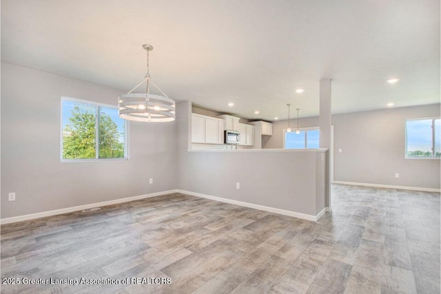2905 Moccasin Dr, Dewitt, MI 48820 - empty room featuring a chandelier, light wood finished floors, and recessed lighting