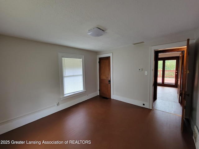 1201 Climax St, Lansing, MI 48912 - spare room with dark wood-type flooring and a textured ceiling