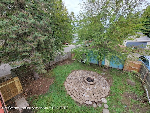 1201 Climax St, Lansing, MI 48912 - fenced backyard with an outdoor fire pit
