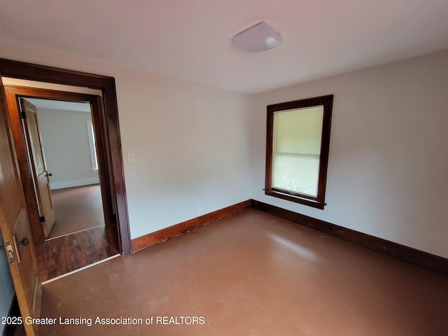 1201 Climax St, Lansing, MI 48912 - spare room with finished concrete flooring and baseboards