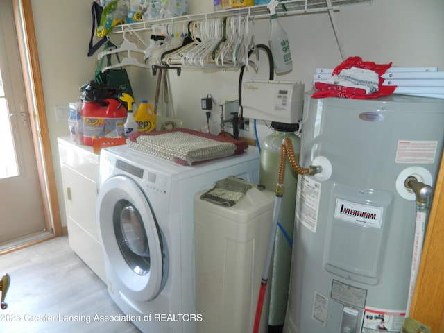 202 Broadway Rd, Houghton Lake, MI 48629 - laundry area featuring electric water heater, washing machine and clothes dryer, and wood finished floors