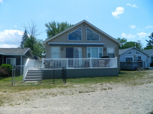 202 Broadway Rd, Houghton Lake, MI 48629 - bungalow-style home featuring a gate and a deck