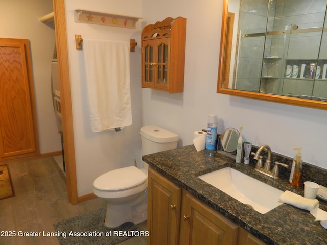 202 Broadway Rd, Houghton Lake, MI 48629 - bathroom with vanity, wood finished floors, and tiled shower