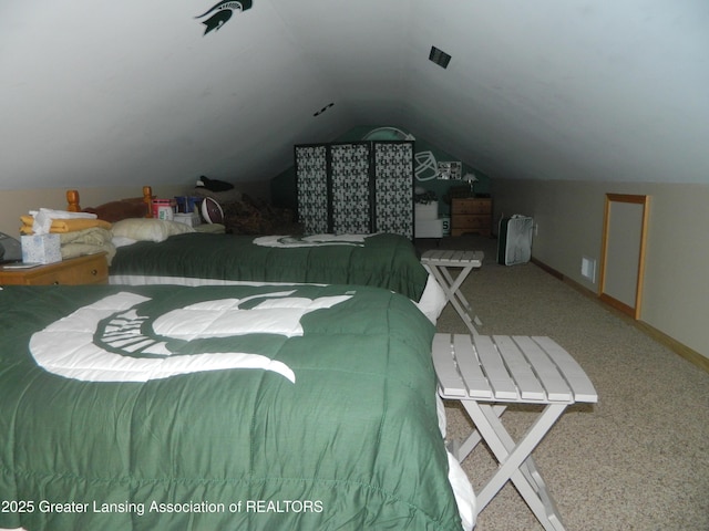 202 Broadway Rd, Houghton Lake, MI 48629 - carpeted bedroom featuring vaulted ceiling and baseboards