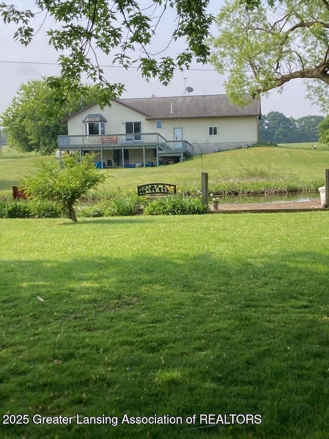4701 W Channel Dr, Stanton, MI 48888 - view of grassy yard featuring a wooden deck