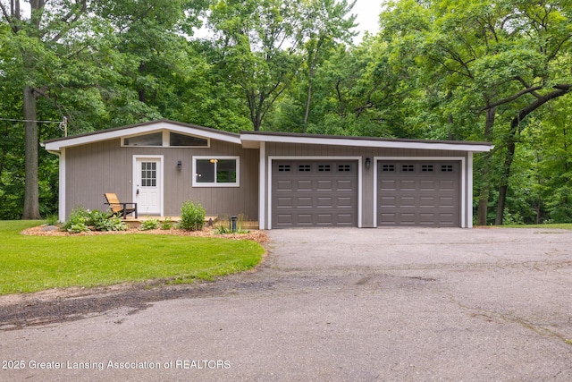 9481 S Clinton Trl, Eaton Rapids, MI 48827 - view of front of property with a front lawn, a garage, and asphalt driveway