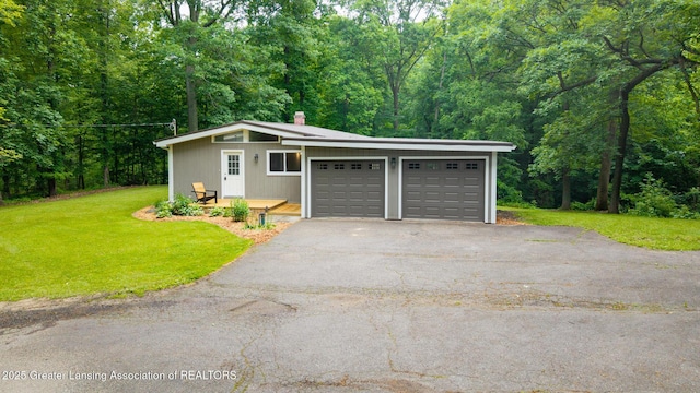 9481 S Clinton Trl, Eaton Rapids, MI 48827 - detached garage featuring a view of trees