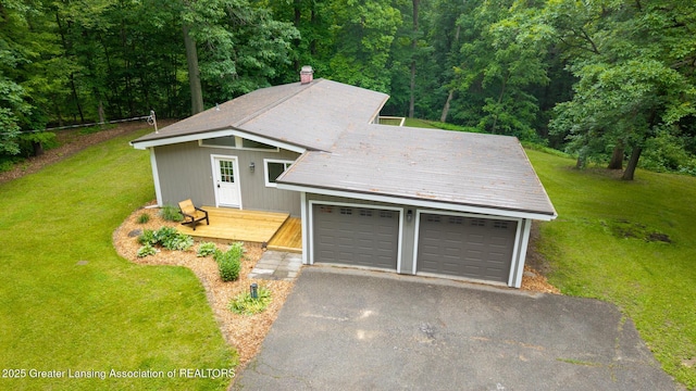 9481 S Clinton Trl, Eaton Rapids, MI 48827 - garage with a forest view and driveway