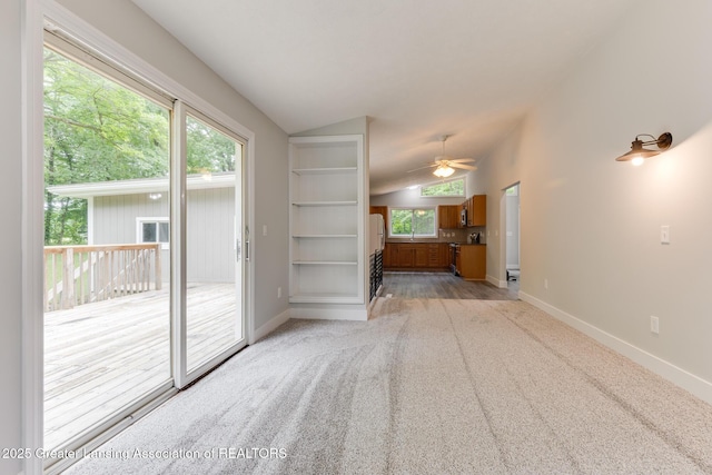 9481 S Clinton Trl, Eaton Rapids, MI 48827 - unfurnished living room featuring lofted ceiling, light carpet, and a ceiling fan