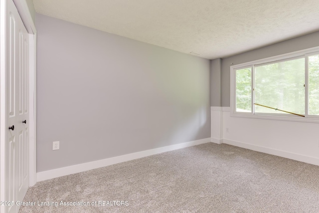9481 S Clinton Trl, Eaton Rapids, MI 48827 - unfurnished room featuring carpet floors and a textured ceiling
