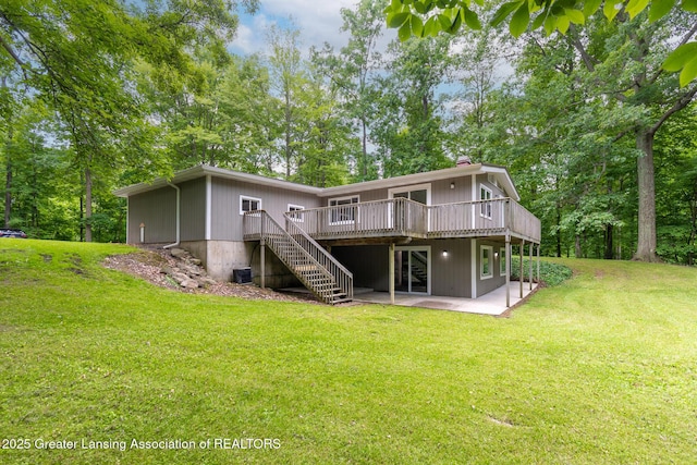 9481 S Clinton Trl, Eaton Rapids, MI 48827 - rear view of house featuring a wooden deck, a patio, stairs, and a lawn