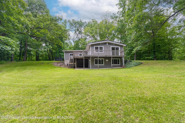 9481 S Clinton Trl, Eaton Rapids, MI 48827 - rear view of property with stairs, a wooden deck, and a lawn