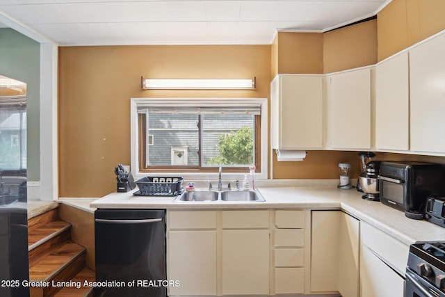 209 N Bowen St, Jackson, MI 49202 - kitchen featuring dishwasher, light countertops, white cabinetry, and gas range