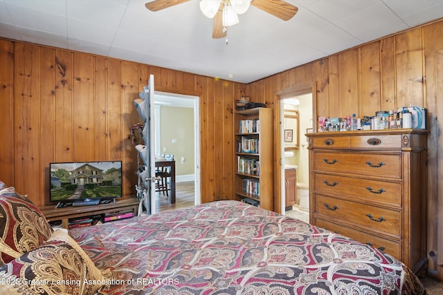 209 N Bowen St, Jackson, MI 49202 - bedroom with wooden walls and connected bathroom
