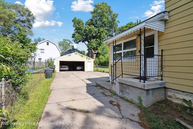 209 N Bowen St, Jackson, MI 49202 - view of side of property with a garage and an outbuilding