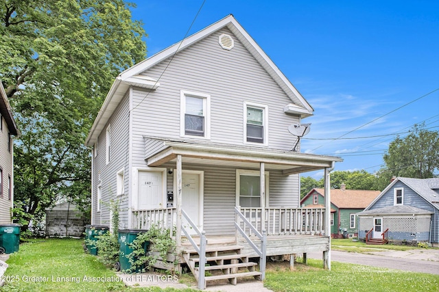 147 Isbell St, Lansing, MI 48910 - view of front facade with a porch and a front lawn