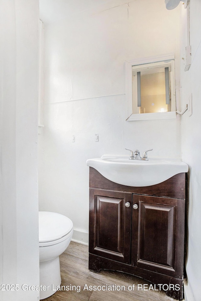 147 Isbell St, Lansing, MI 48910 - half bath featuring vanity and wood finished floors