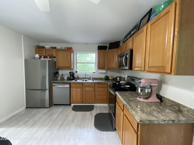 4175 Marshall Rd, Charlotte, MI 48813 - kitchen featuring appliances with stainless steel finishes, light wood-type flooring, ceiling fan, and brown cabinets