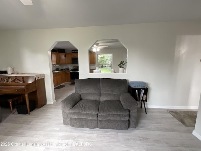 4175 Marshall Rd, Charlotte, MI 48813 - living area featuring ceiling fan, light wood finished floors, and arched walkways