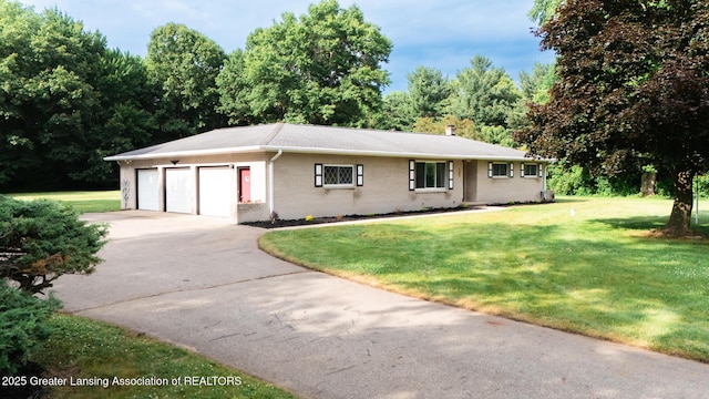 62 W Sherwood Rd, Okemos, MI 48864 - single story home with driveway, a front lawn, brick siding, and an attached garage