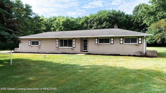 62 W Sherwood Rd, Okemos, MI 48864 - view of front facade featuring brick siding, a front lawn, and a chimney