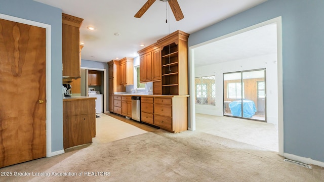 62 W Sherwood Rd, Okemos, MI 48864 - kitchen with washer / dryer, a ceiling fan, dishwasher, open shelves, and light carpet