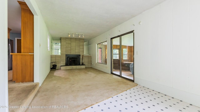 62 W Sherwood Rd, Okemos, MI 48864 - unfurnished living room featuring carpet flooring and a fireplace