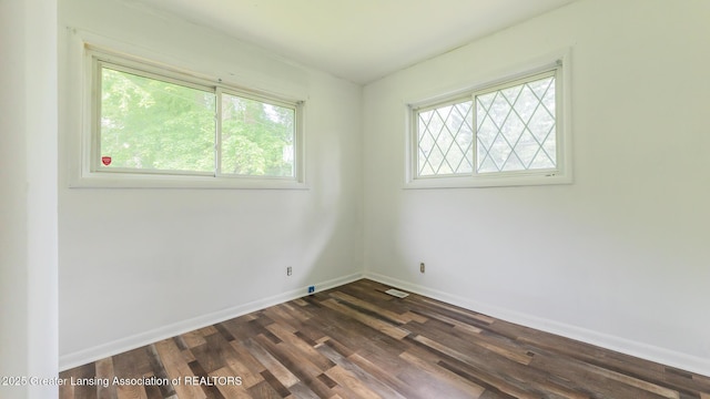 62 W Sherwood Rd, Okemos, MI 48864 - empty room featuring plenty of natural light and dark wood-style flooring