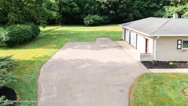 62 W Sherwood Rd, Okemos, MI 48864 - view of grassy yard with a detached garage