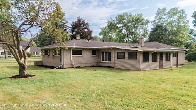 62 W Sherwood Rd, Okemos, MI 48864 - back of property featuring a chimney, a lawn, and brick siding