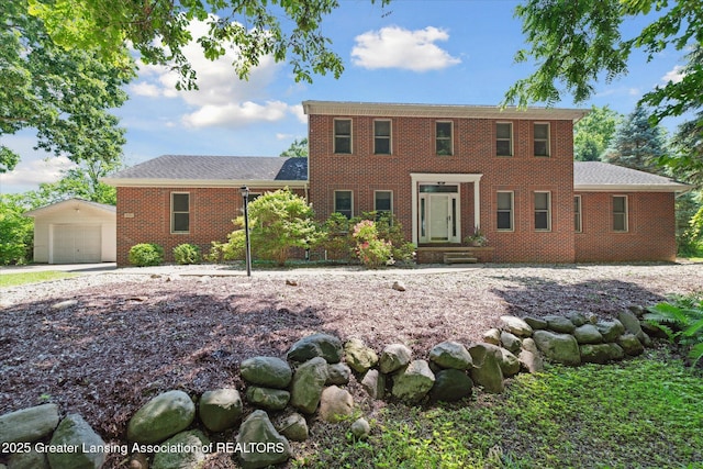 4084 Hulett Rd, Okemos, MI 48864 - colonial inspired home featuring an outdoor structure, brick siding, and a garage