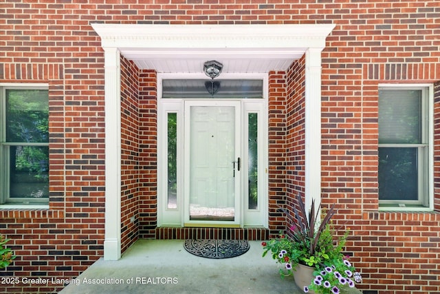4084 Hulett Rd, Okemos, MI 48864 - view of exterior entry featuring brick siding