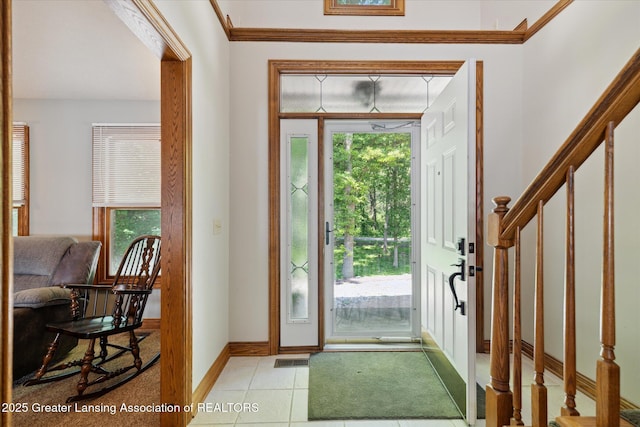 4084 Hulett Rd, Okemos, MI 48864 - foyer featuring healthy amount of natural light, stairway, light tile patterned floors, and ornamental molding