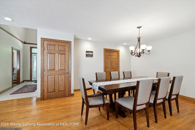 4084 Hulett Rd, Okemos, MI 48864 - dining room featuring a chandelier, light wood finished floors, and recessed lighting