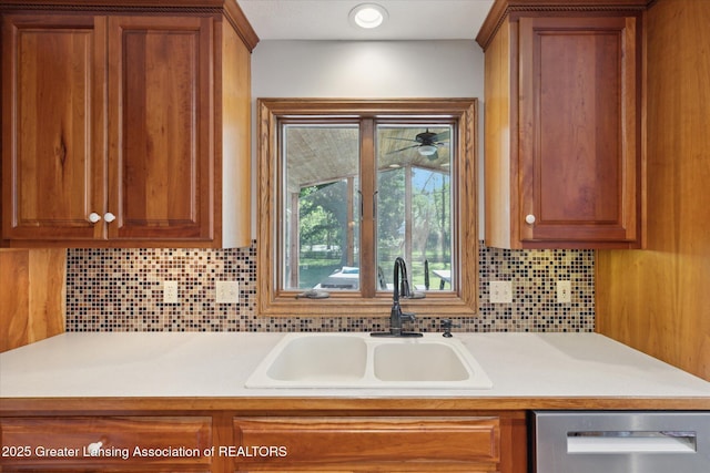 4084 Hulett Rd, Okemos, MI 48864 - kitchen featuring dishwasher, brown cabinetry, light countertops, and tasteful backsplash