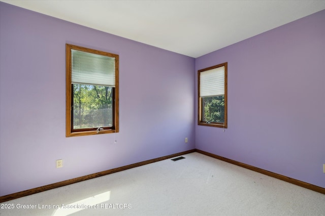 4084 Hulett Rd, Okemos, MI 48864 - spare room featuring carpet floors and baseboards