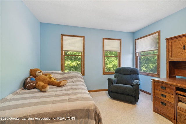 4084 Hulett Rd, Okemos, MI 48864 - bedroom featuring baseboards and light carpet