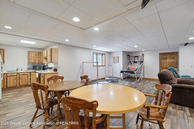 4084 Hulett Rd, Okemos, MI 48864 - dining area with light wood-style floors, a paneled ceiling, and recessed lighting