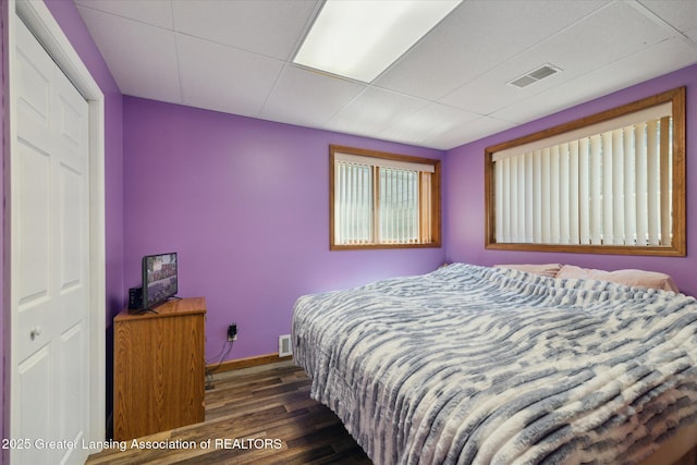 4084 Hulett Rd, Okemos, MI 48864 - bedroom featuring dark wood-style flooring and a paneled ceiling