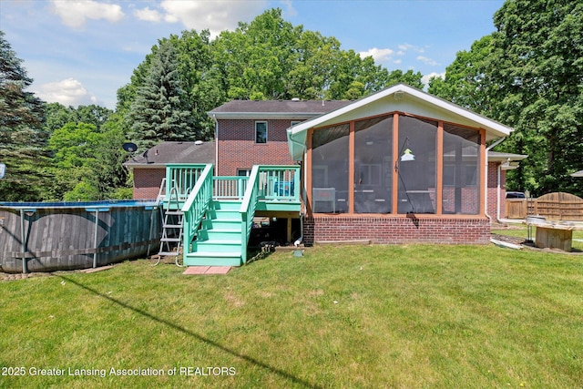 4084 Hulett Rd, Okemos, MI 48864 - rear view of property featuring brick siding, a sunroom, stairs, a wooden deck, and an outdoor pool