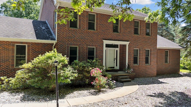 4084 Hulett Rd, Okemos, MI 48864 - view of front of house with a shingled roof and brick siding