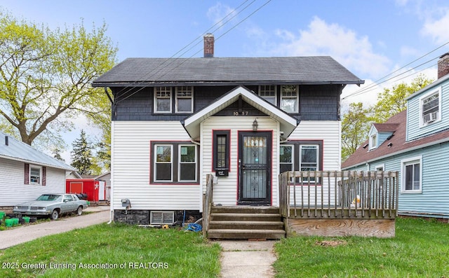 1017 W Oakland Ave, Lansing, MI 48915 - view of front facade with a chimney and a front yard