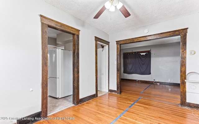 1017 W Oakland Ave, Lansing, MI 48915 - unfurnished room with wood finished floors, a ceiling fan, and a textured ceiling