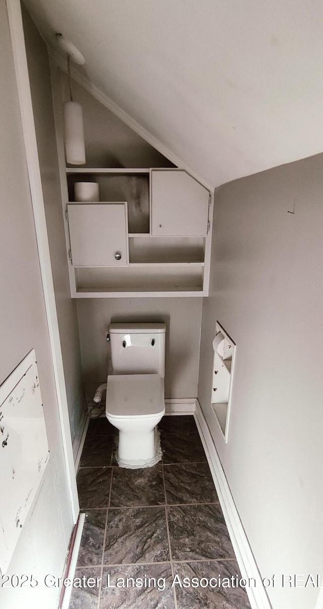 1017 W Oakland Ave, Lansing, MI 48915 - bathroom with lofted ceiling and marble look tiles