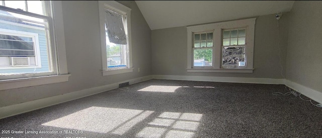 1017 W Oakland Ave, Lansing, MI 48915 - carpeted empty room featuring lofted ceiling and baseboards