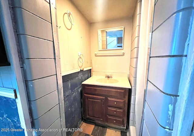 1017 W Oakland Ave, Lansing, MI 48915 - bathroom featuring vanity and concrete block wall